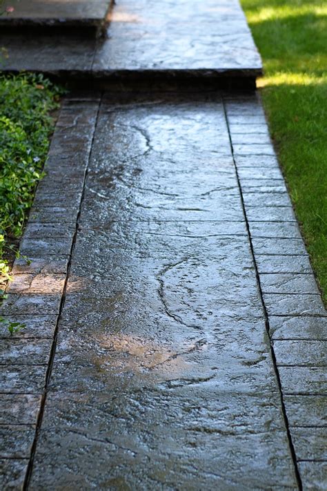 Seamless Stamped Concrete sidewalk with hand tooled border and porch with 2 inch rough granite ...