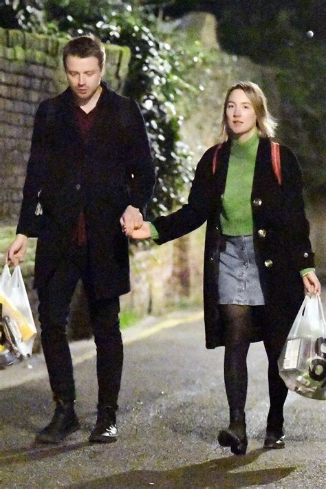 Saoirse Ronan steps out for an evening stroll while holding hands with Scottish actor Jack ...