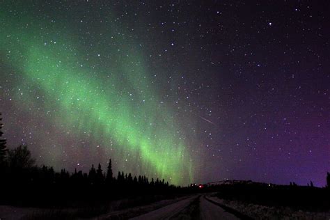 an image of the night sky with green and purple aurora bores in the ...