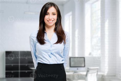 Smiling young female manager in her office 754835 Stock Photo at Vecteezy