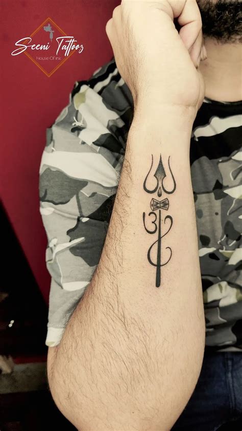 a man's arm with a tattoo on it that has a cross and hook