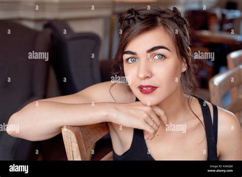 Portrait of mindful attractive young woman in modern cafe interior Stock Photo - Alamy