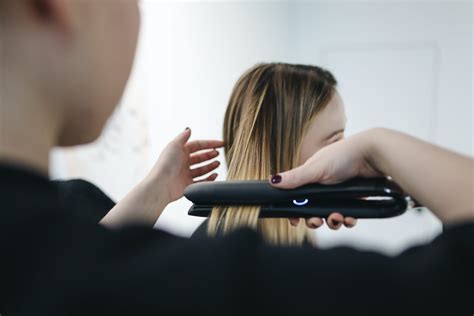 Selective Focus Photo of Person Ironing a Woman's Hair · Free Stock Photo