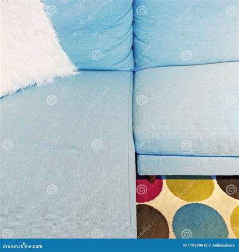 Fluffy White Cushion on a Blue Textile Sofa Stock Photo - Image of fancy, detail: 110889618