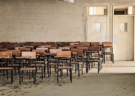 "Empty School Desks" by Stocksy Contributor "Gabriel J. Diaz" - Stocksy