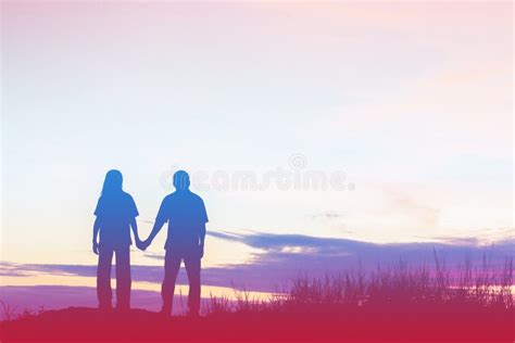 Silhouette of a Female and Male Holding Hands at Sunset Stock Photo ...