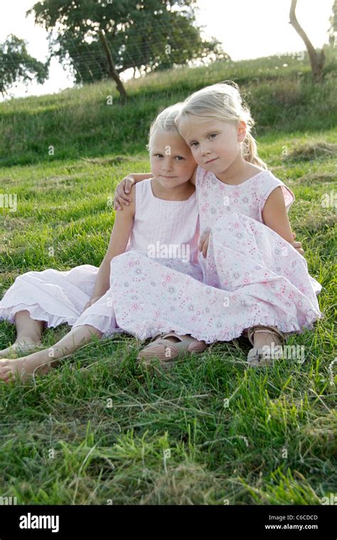 Portrait of two girl friends putting their arms around their shoulders in summer, Eyendorf ...