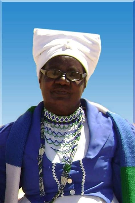 A Damara woman in Damara traditional wear and colours (blue, white and green)