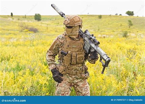 Soldier in a Special Military Uniform with Sniper Rifle in the Field ...