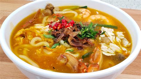 Banh Canh Cua is aka Vietnamese Crab Udon, an orange-colored thick and round that consists of ...