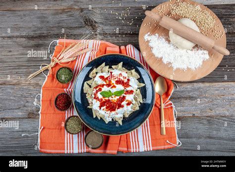 Plates of traditional Turkish food. Turkish Ravioli (Mantı) with yoghurt and tomato sauce Stock ...