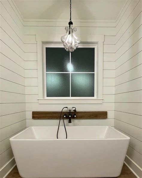 Large White Freestanding Soaking Bathtub With a Retro Faucet - Soul & Lane