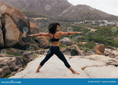 Barefoot Woman Practicing Yoga Exercises Outdoors while Standing on a ...