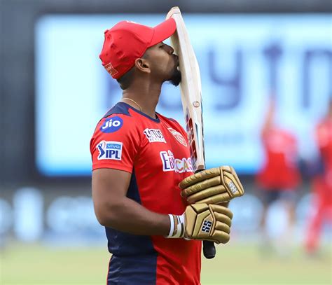 Nicholas Pooran kisses his bat during a practice session | ESPNcricinfo.com