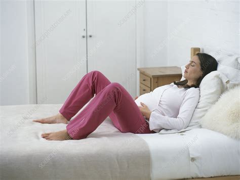 Pregnant woman lying on bed - Stock Image - C052/1232 - Science Photo ...