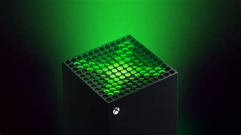 a black box with green lights on the top and bottom part is lit up in dark lighting