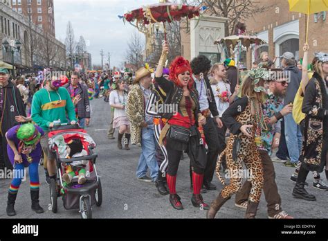 A crowd of colorful, rowdy people in creative costumes have a good time ...