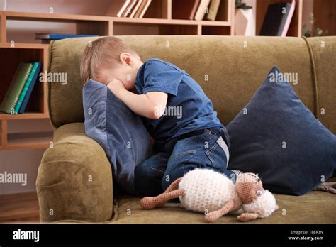 Sad little boy crying at home Stock Photo - Alamy