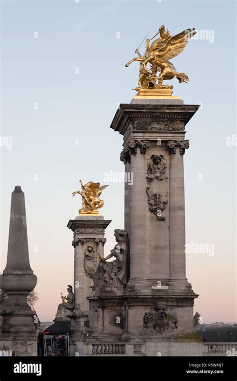 Two art nouveau golden-winged horses on the Pont Alexandre III, a deck arch bridge that spans ...