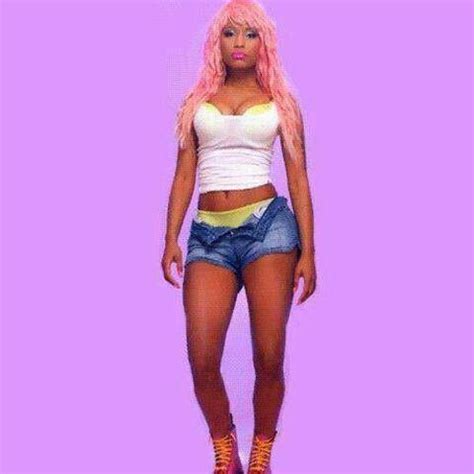 a woman with pink hair and short shorts standing in front of a purple ...