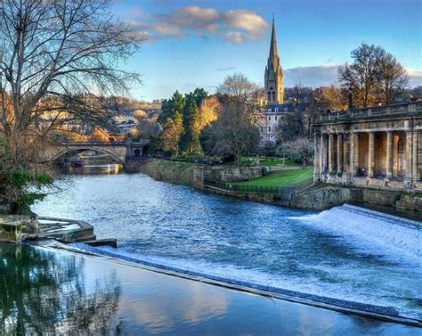 View across the weir on the River Avon at Bath. The Beautiful City of ...