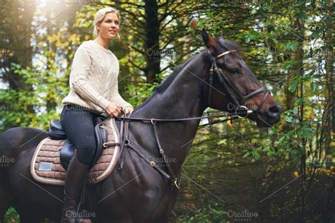 Lady riding a brown horse in park | High-Quality People Images ~ Creative Market