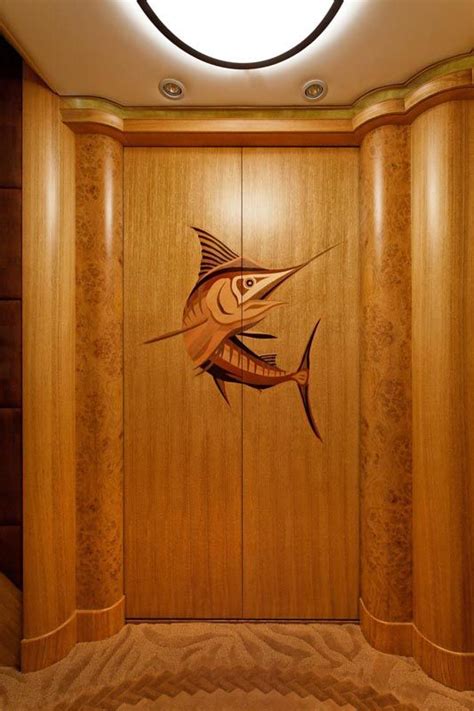 a fish carved into the side of a wooden paneled wall in a hotel lobby