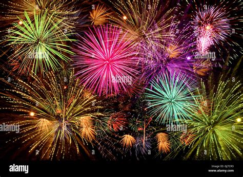 Colorful firework celebration on dark night sky background. Beautiful fireworks show on clear ...