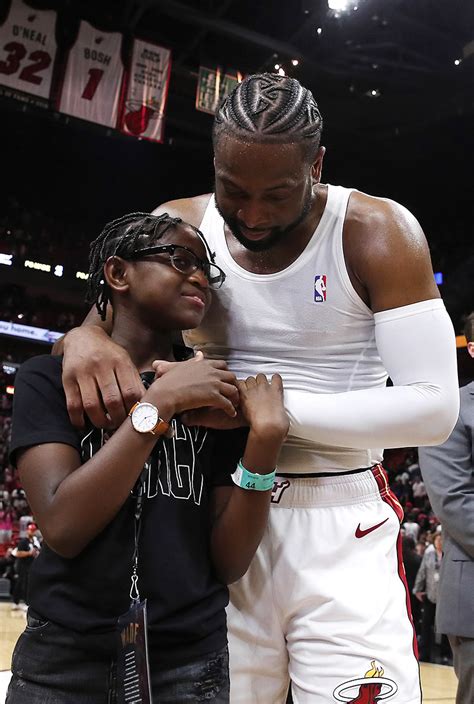 Dwyane Wade #3 of the Miami Heat hugs his son, Zion Wade, after his ...