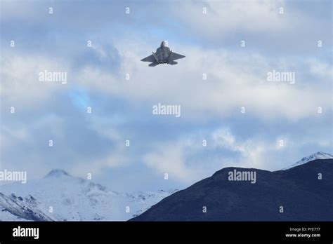 A U.S. Air Force F-22 Raptor flies over Joint Base Elmendorf-Richardson, Alaska, Oct. 26, 2018 ...