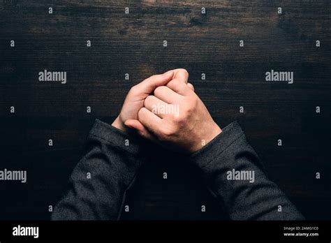 Businesswoman hands wringing at office desk, top view of insecurity ...