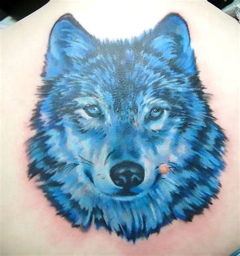 A tattoo of a blue wolf on the man's back. Style: Realistic. Color ...