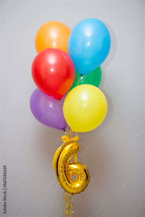 multi-colored balloons on a black background, golden number 6 foil ...