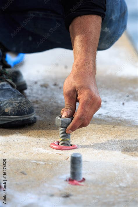 Setting stud bolt into adhesive chemical anchor Stock Photo | Adobe Stock