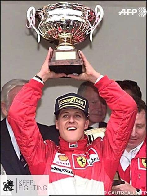 Michael holds his trophy aloft on the podium on 11 May 1997 after ...