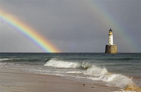 Rainbow And A Lighthouse Photograph by Duncan Shaw - Fine Art America