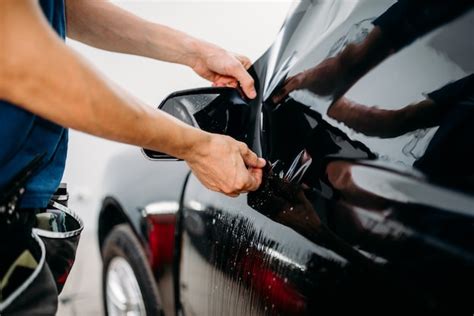 Premium Photo | Male specialist work with car, tinting film ...