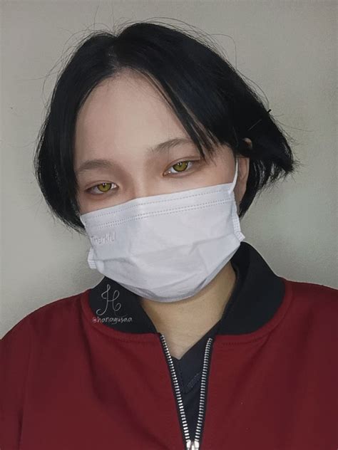 a woman wearing a white face mask with black hair