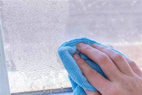 Condensation on Windows in Winter, Wiping with a Dry Cloth Stock Image ...