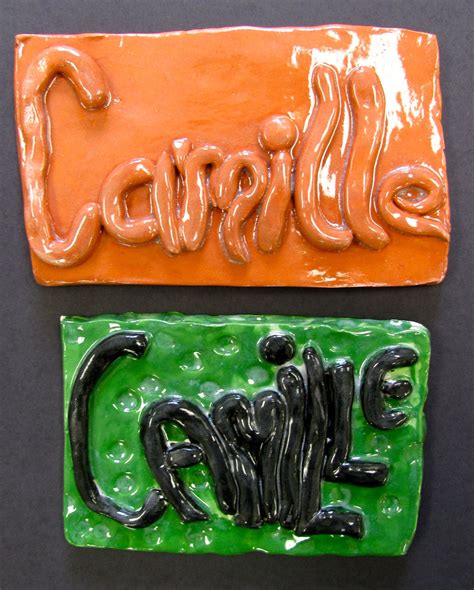 two ceramic magnets with the word cake on one and the word candy on the other