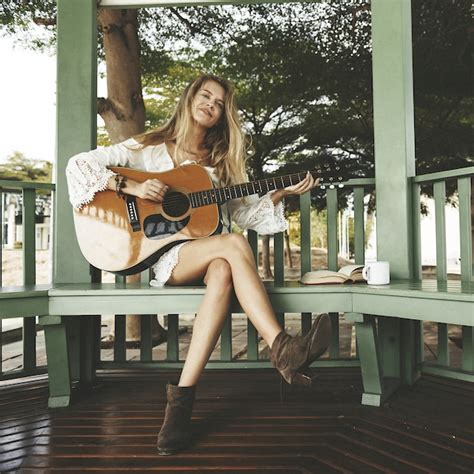 Premium Photo | Beautiful singer songwriter with her guitar