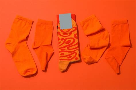 Premium Photo | Socks with blank label on orange background