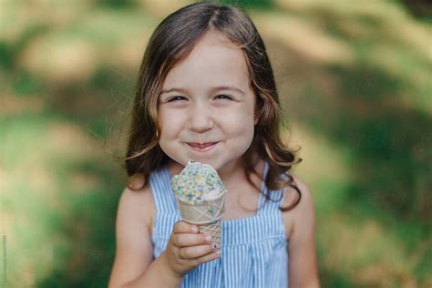 "Cute And Happy Young Girl Eating Ice Cream Outside" by Stocksy ...