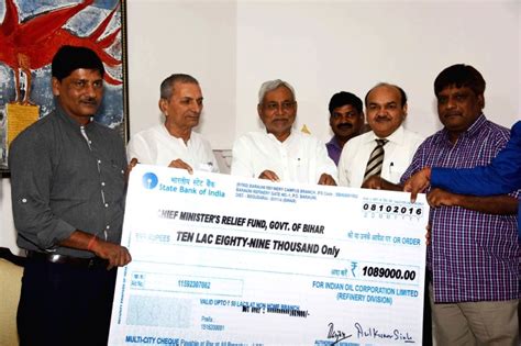 Barauni refinery workers presents a cheque for the Relief fund