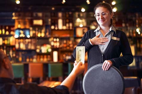 Premium Photo | Waitress takes the tip. the waiter female receives a tip from the client at the ...