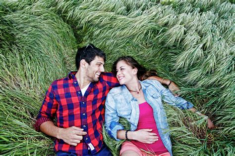 Couple laying in grass - Stock Photo - Dissolve