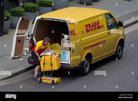 DHL delivery driver unloading van in City of London Stock Photo - Alamy