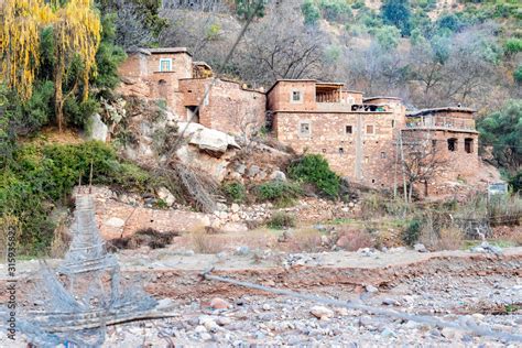 Berber village by river in Atlas mountains, Morocco Stock Photo | Adobe ...