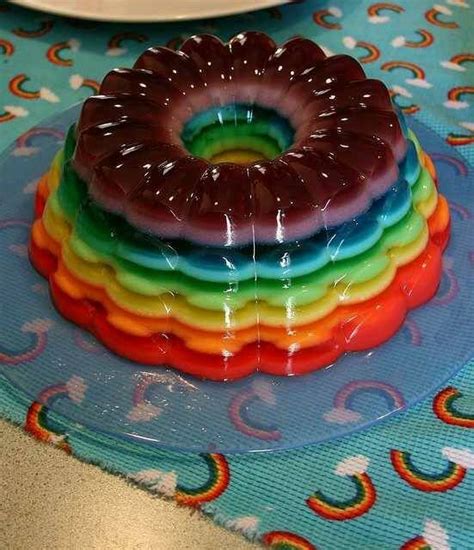 there is a rainbow cake on the table