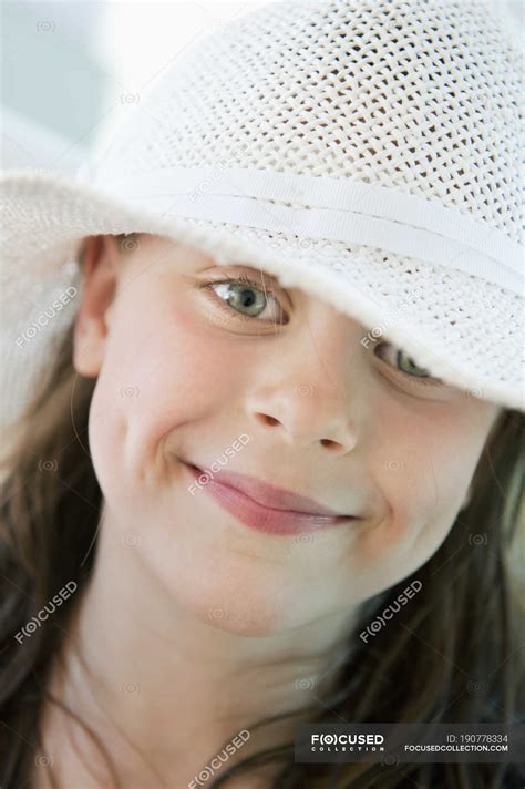 Portrait of girl wearing sun hat, focus on foreground — female, outdoors - Stock Photo | #190778334